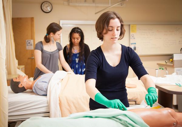 A student of the LPN program in BC examining a torso model
