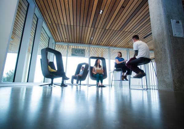 People in modern chairs in a light airy room