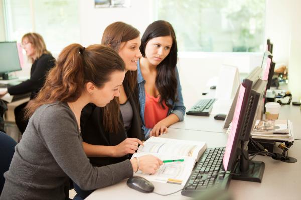 Legal Administrative Assistant and Accounting Assistant students of the Applied Business Technology conducting an online research together