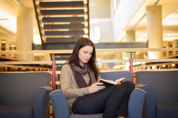 A Bachelor of Arts in English Honours, Major, Minor student studying for her writing courses in the library