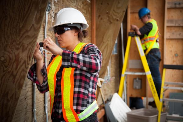 A female Electrical Apprenticeship students working on a construction site