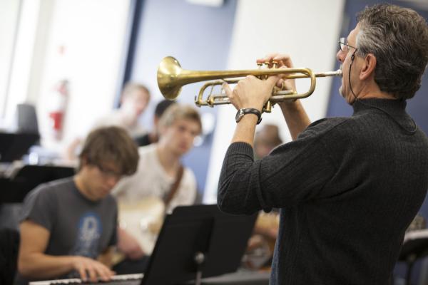 An instructor of the Music - Diploma in Jazz Studies program playing a trumpet