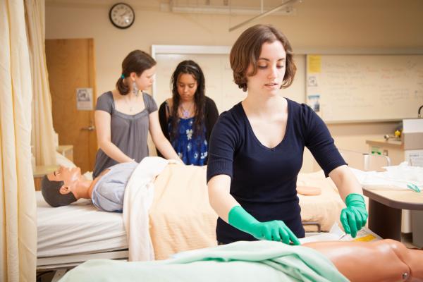 A student of the LPN program in BC examining a torso model