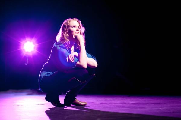 A female student of the Theatre program on stage