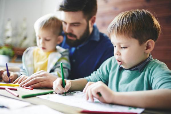 An early Childhood Education worker is taking care of two boys