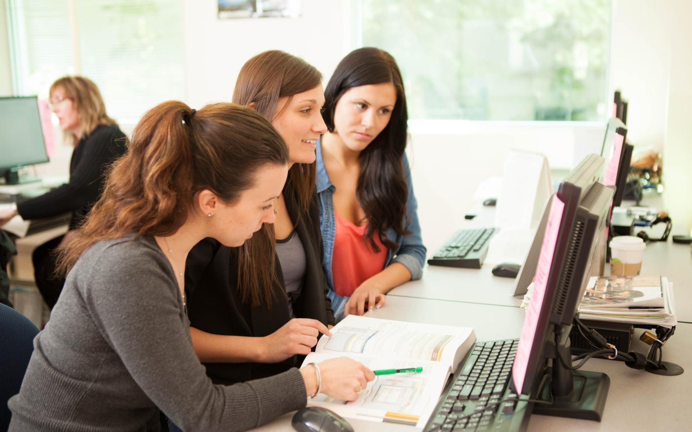 Legal Administrative Assistant and Accounting Assistant students of the Applied Business Technology conducting an online research together