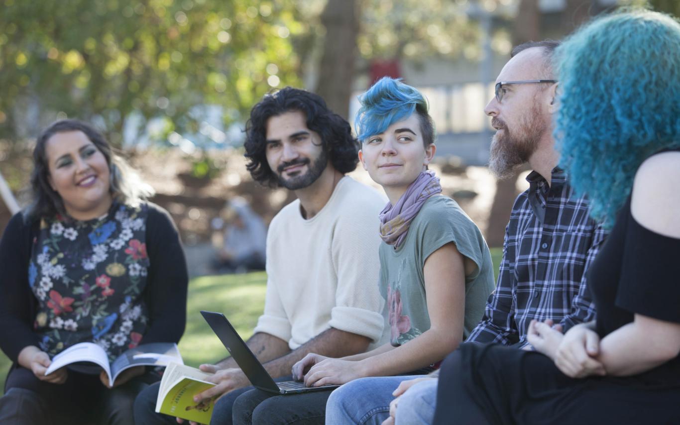 Degree in Journalism students having an outdoor workshop