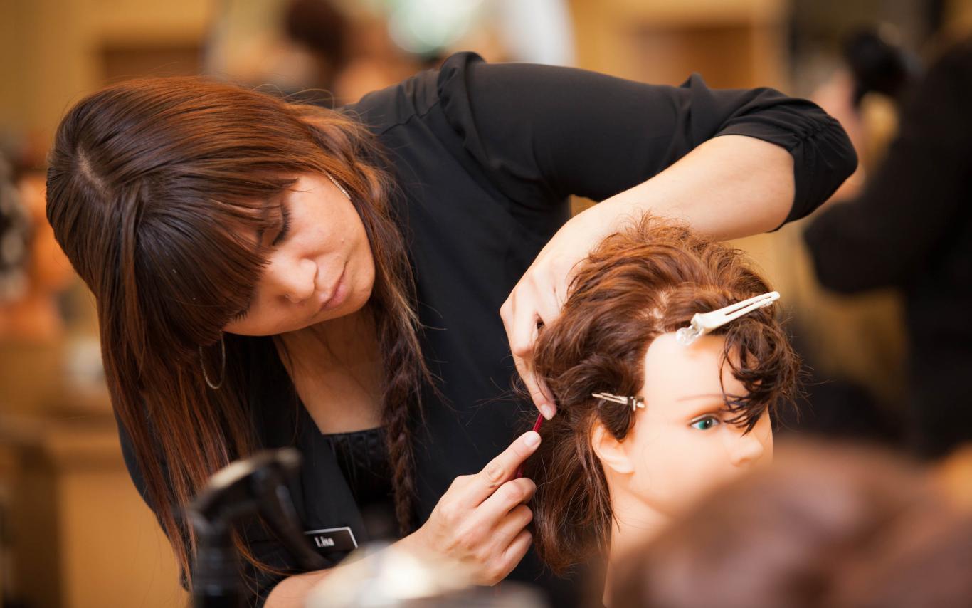 A Hair Stylist course student at VIU's hairdressing school