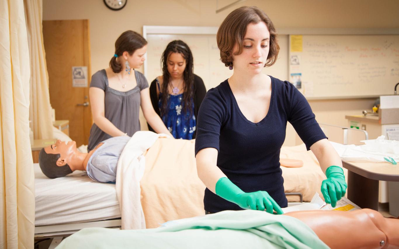 A student of the LPN program in BC examining a torso model