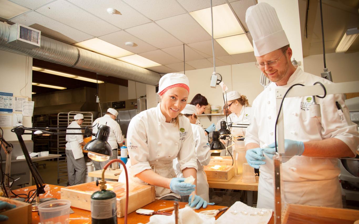 Students of the Professional Baking and Pastry Arts program decorating tasty treats at VIU's baking school