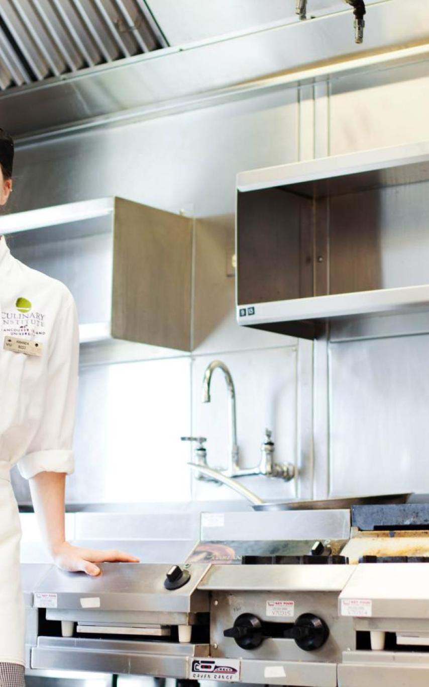 Student standing in kitchen