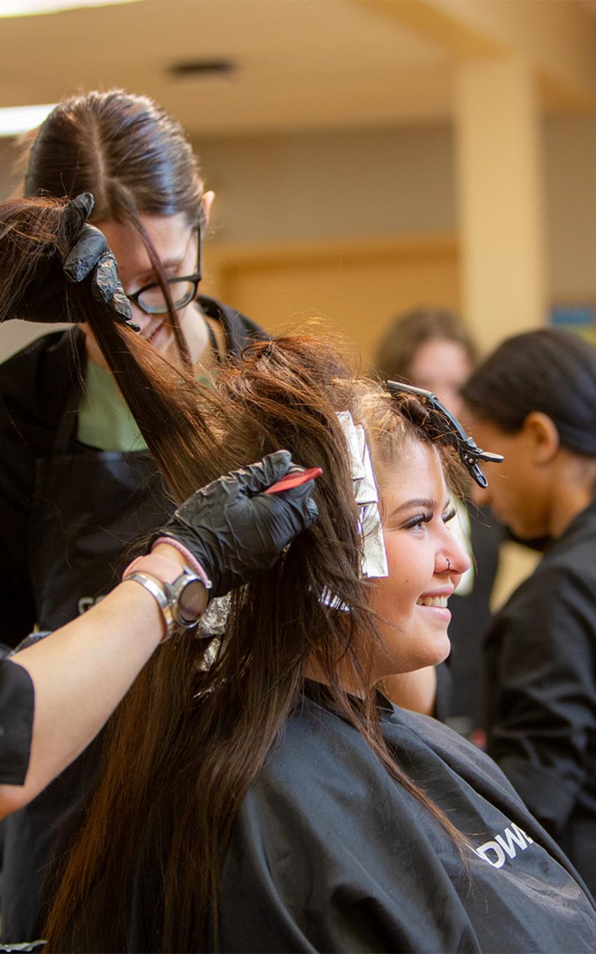 VIU hairstylist student cutting a client's hair.