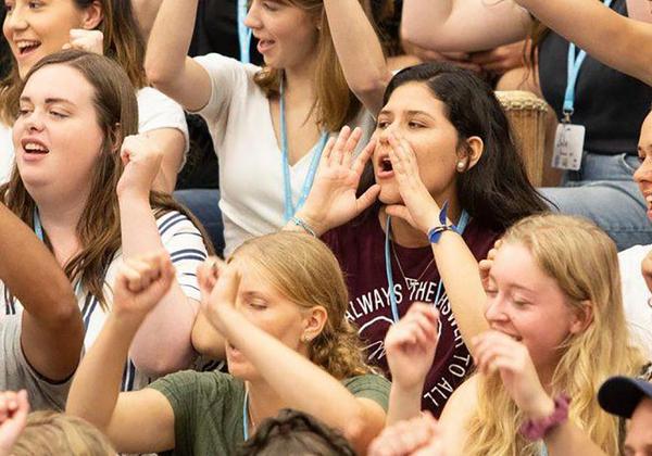 A crowd of students cheering at an event