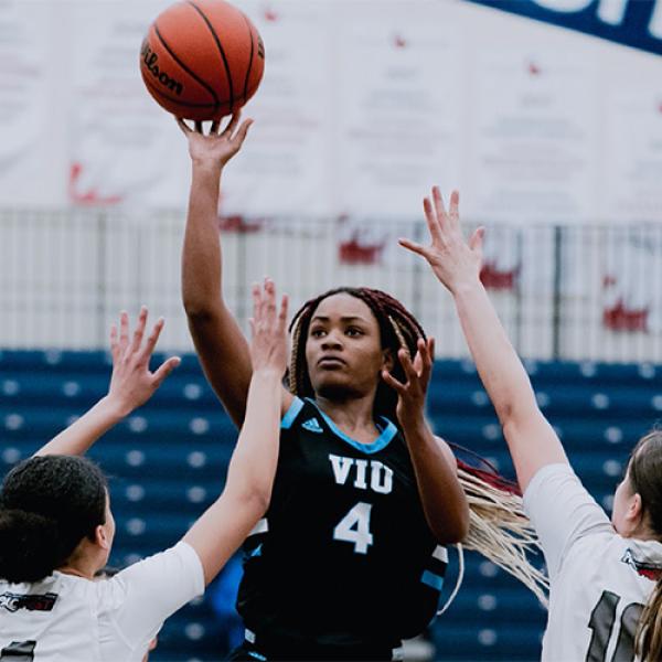 Young woman playing basketball.