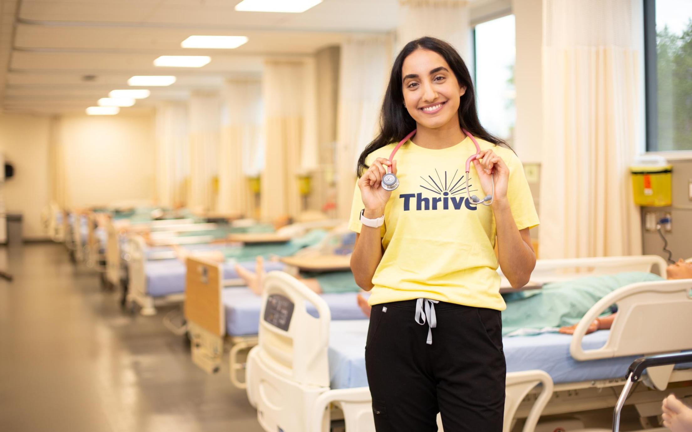 Ashley Sandhu, a Wellness Promoter, in the nursing lab, where she is a student