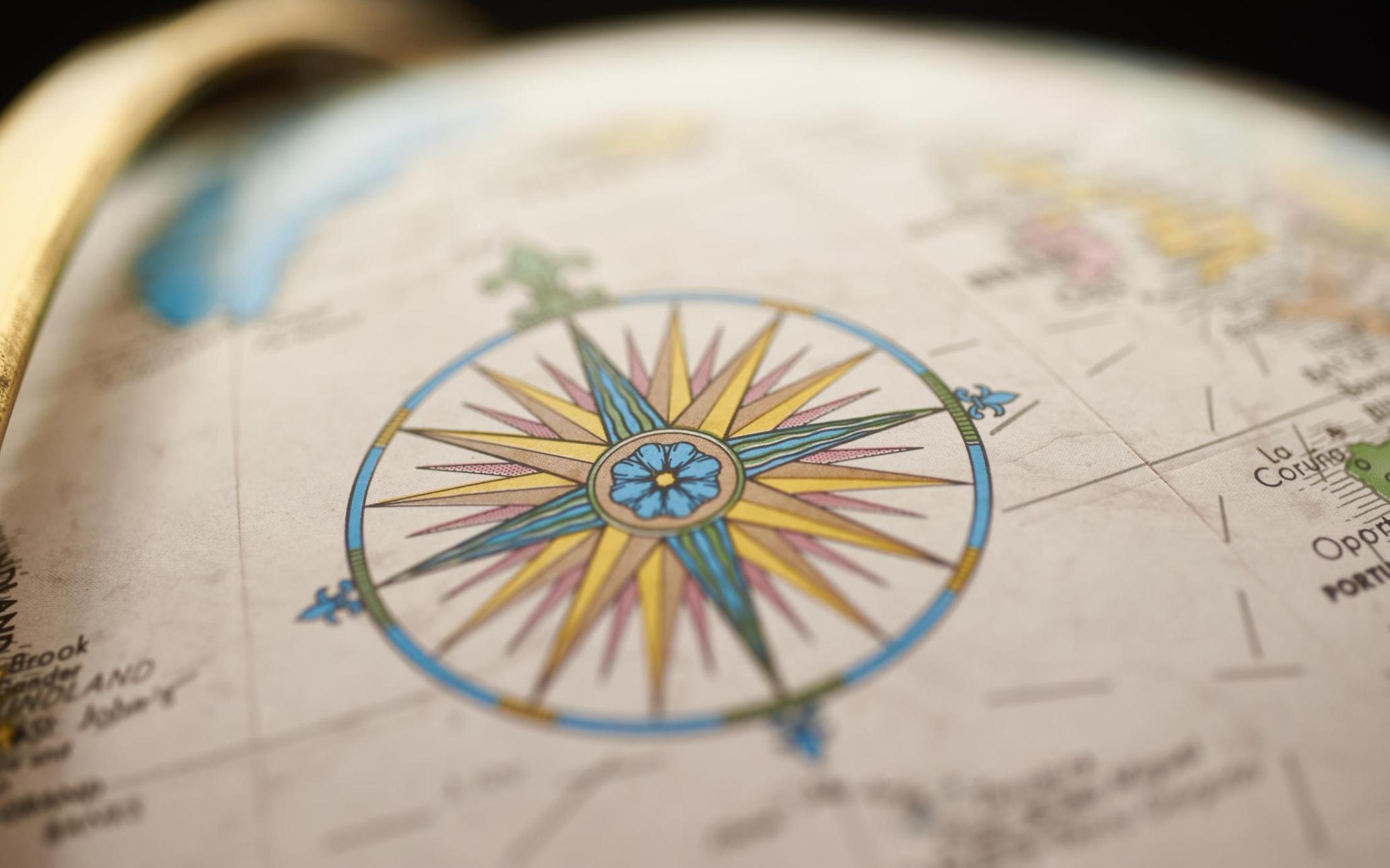 Picture of a compass rose on a globe