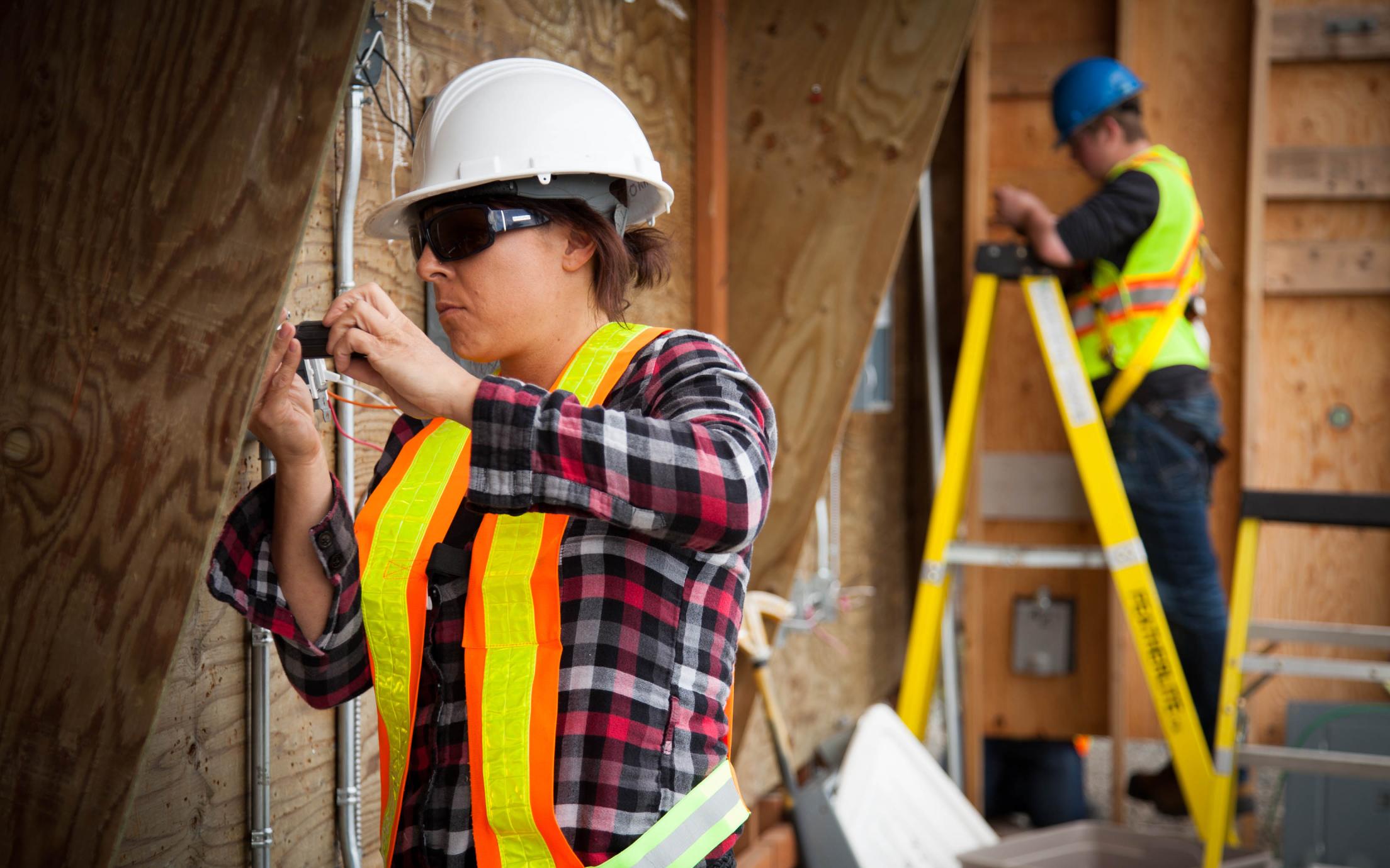 A female Electrical Apprenticeship students working on a construction site 