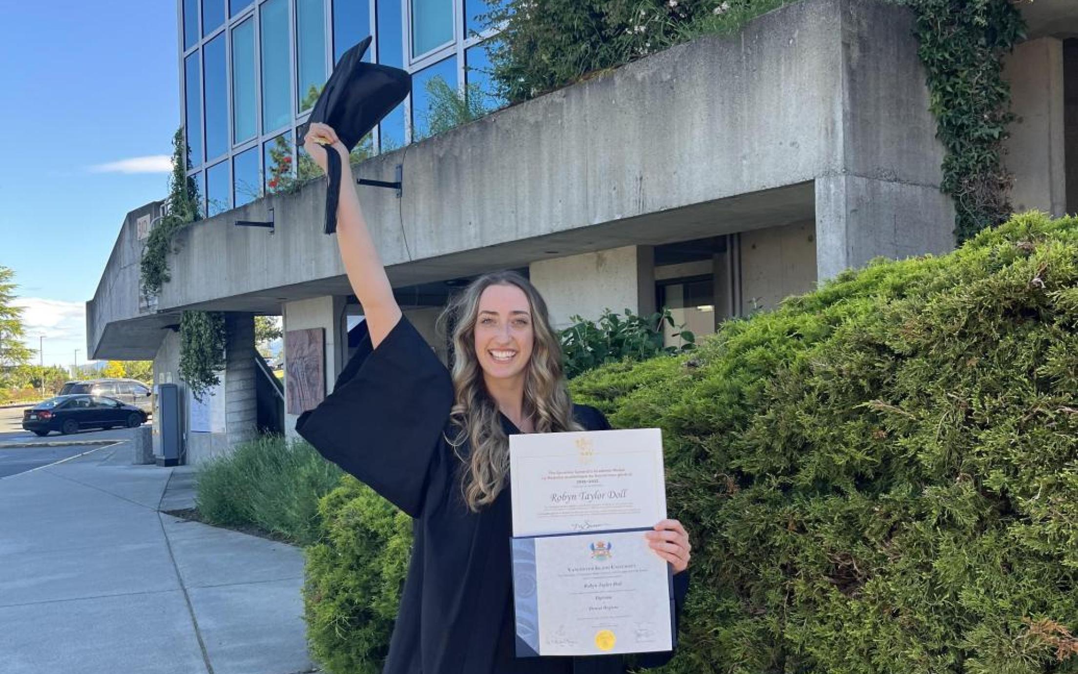 VIU graduate Robyn Doll smiling with diploma