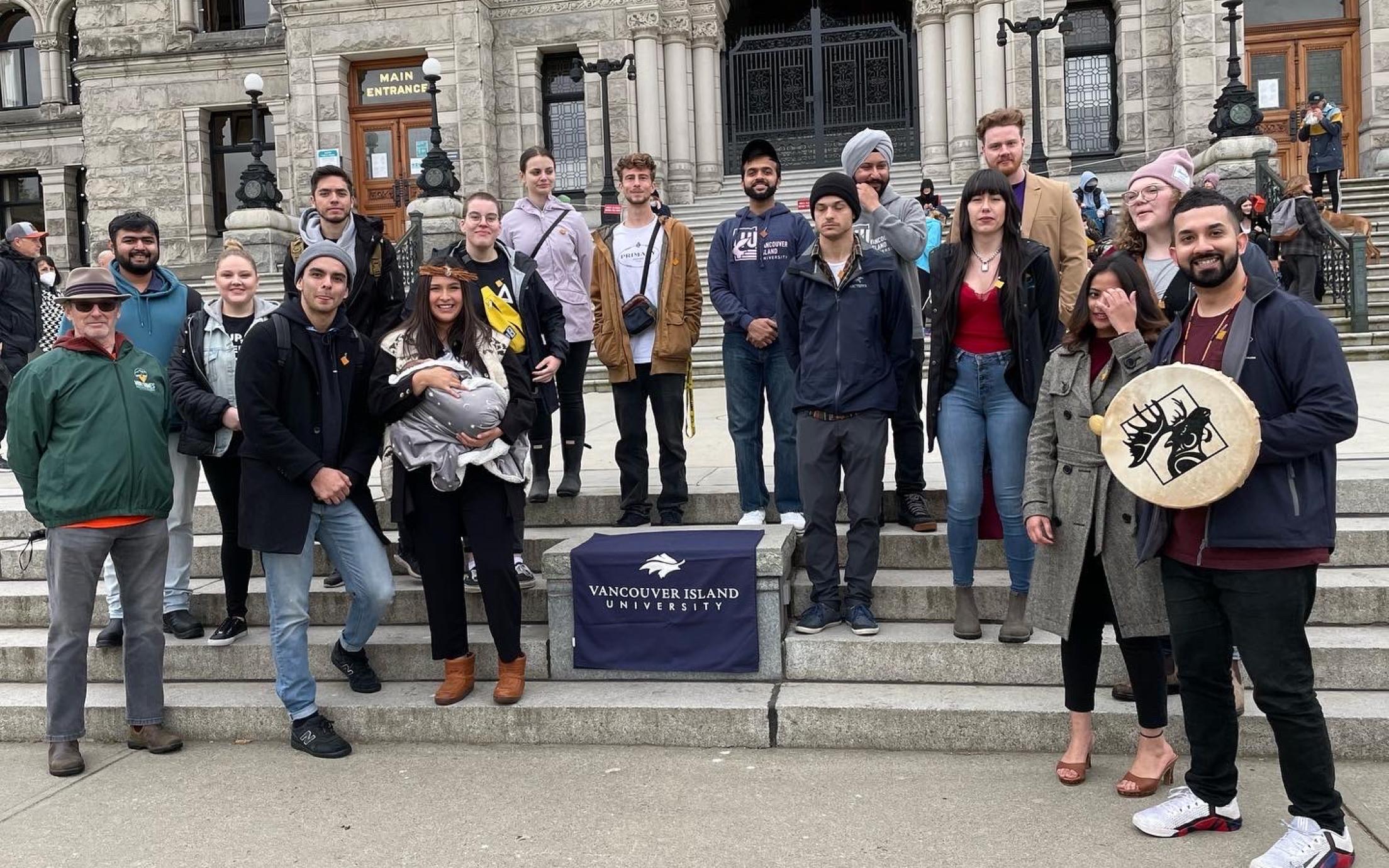 group shot of VIU students and staff standing in front of the Legislature