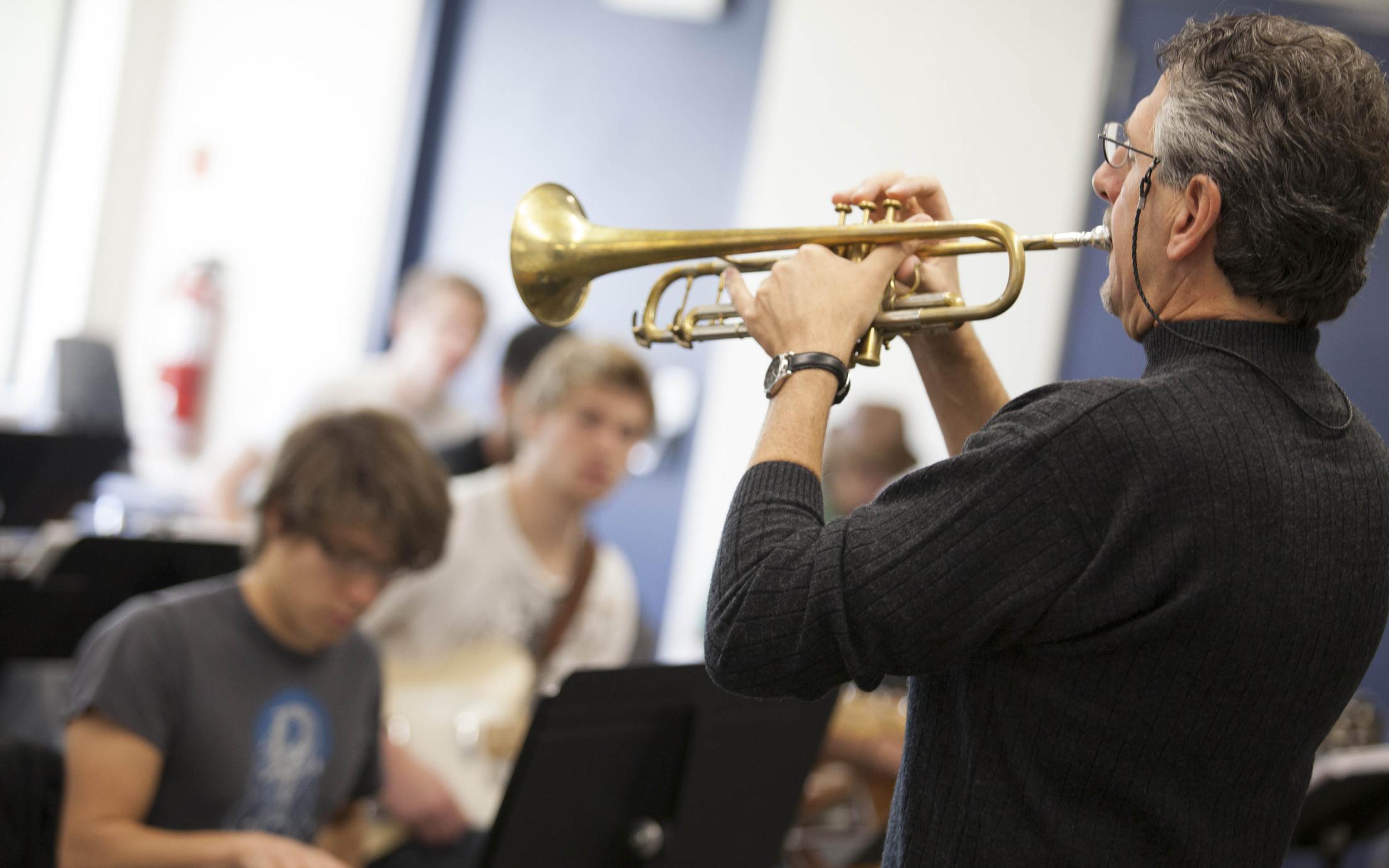 An instructor of the Music - Diploma in Jazz Studies program playing a trumpet