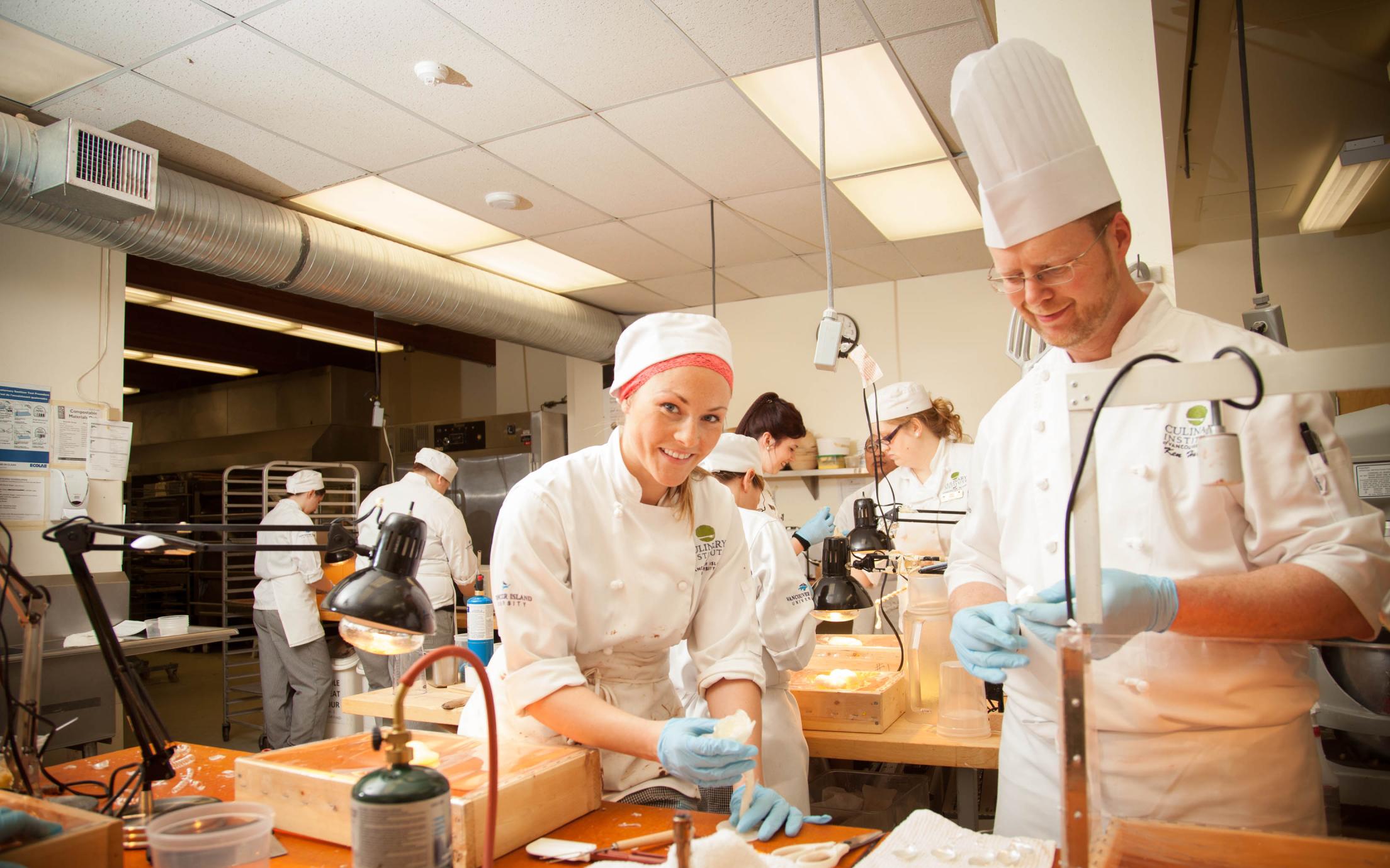 Students of the Professional Baking and Pastry Arts program decorating tasty treats at VIU's baking school