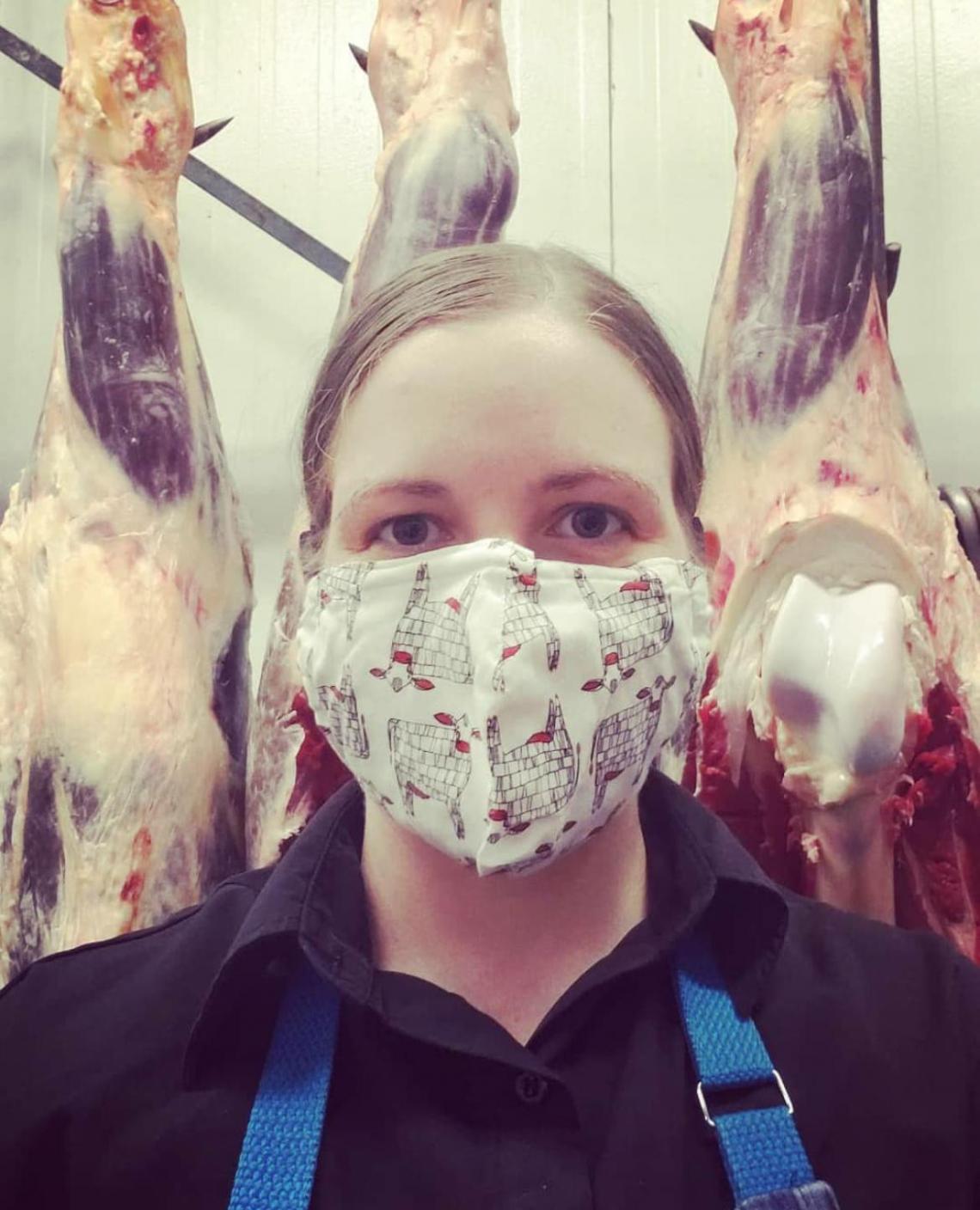 Girl wearing mask in a butcher shop