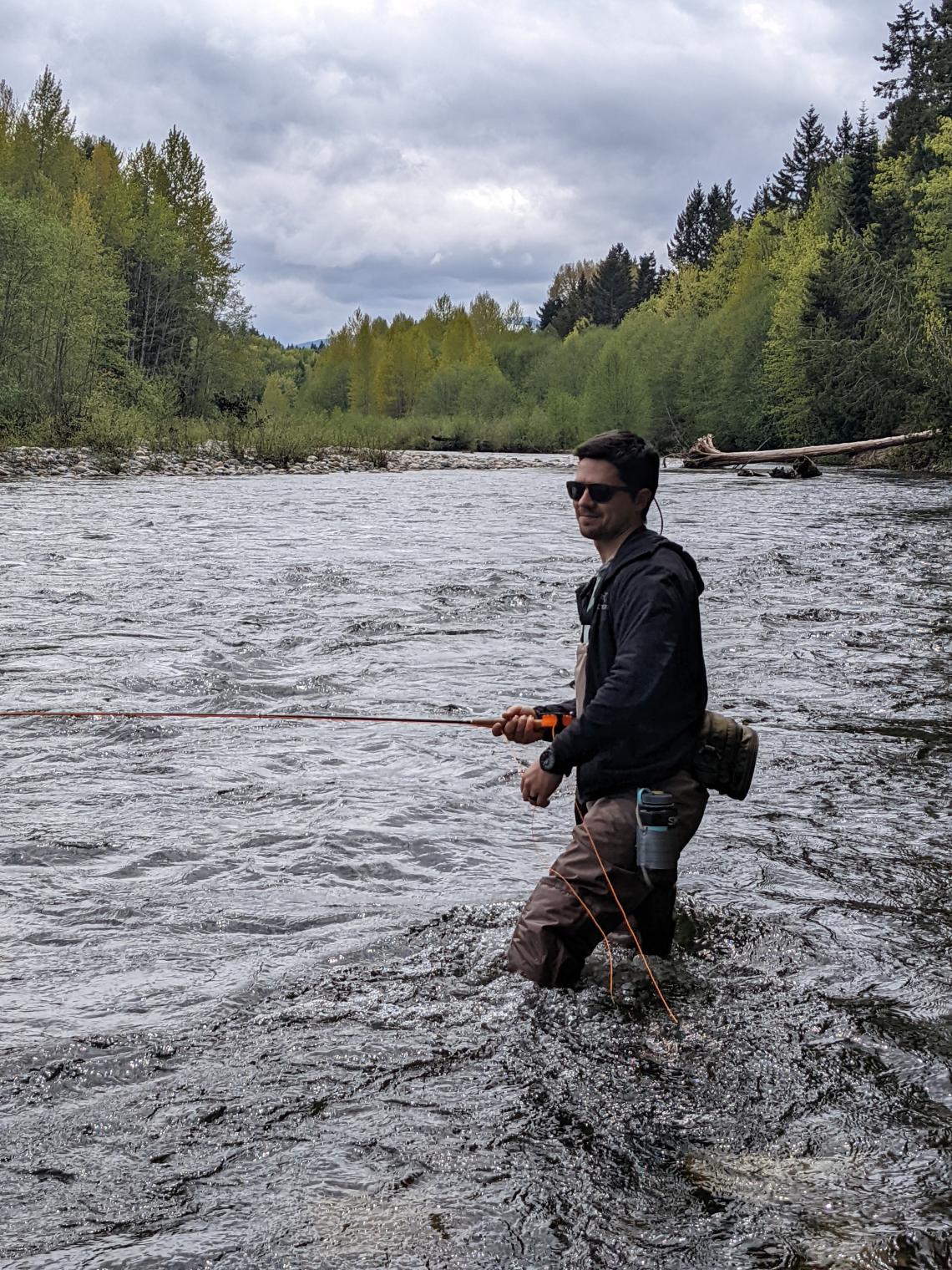 Joe Clark fishing in a river