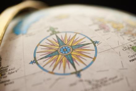 Picture of a compass rose on a globe
