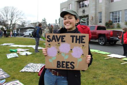 Emma Simard Provencal holding a Save the Bees sign
