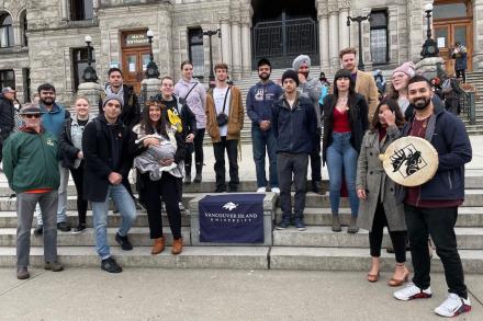group shot of VIU students and staff standing in front of the Legislature