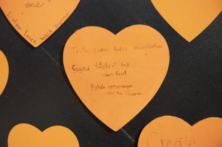 Orange heart reads "truth comes before reconciliation" and "Ganu tlalire lax" (don't forget) and kaeda gangananam (for the children)