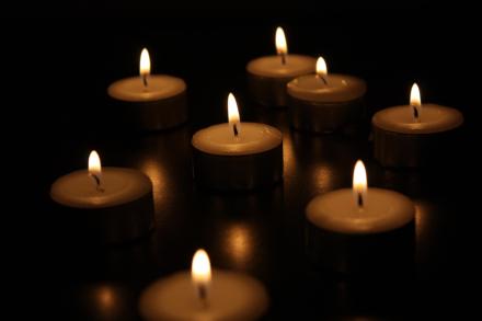 Closeup of lit candles in a dark area