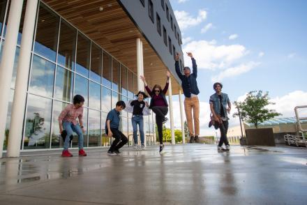 Students jumping outside the Health and Science Centre