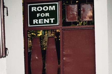 Room for rent sign in a door