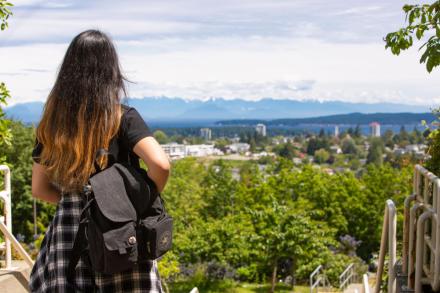 Student looks at the view wearing a backpack