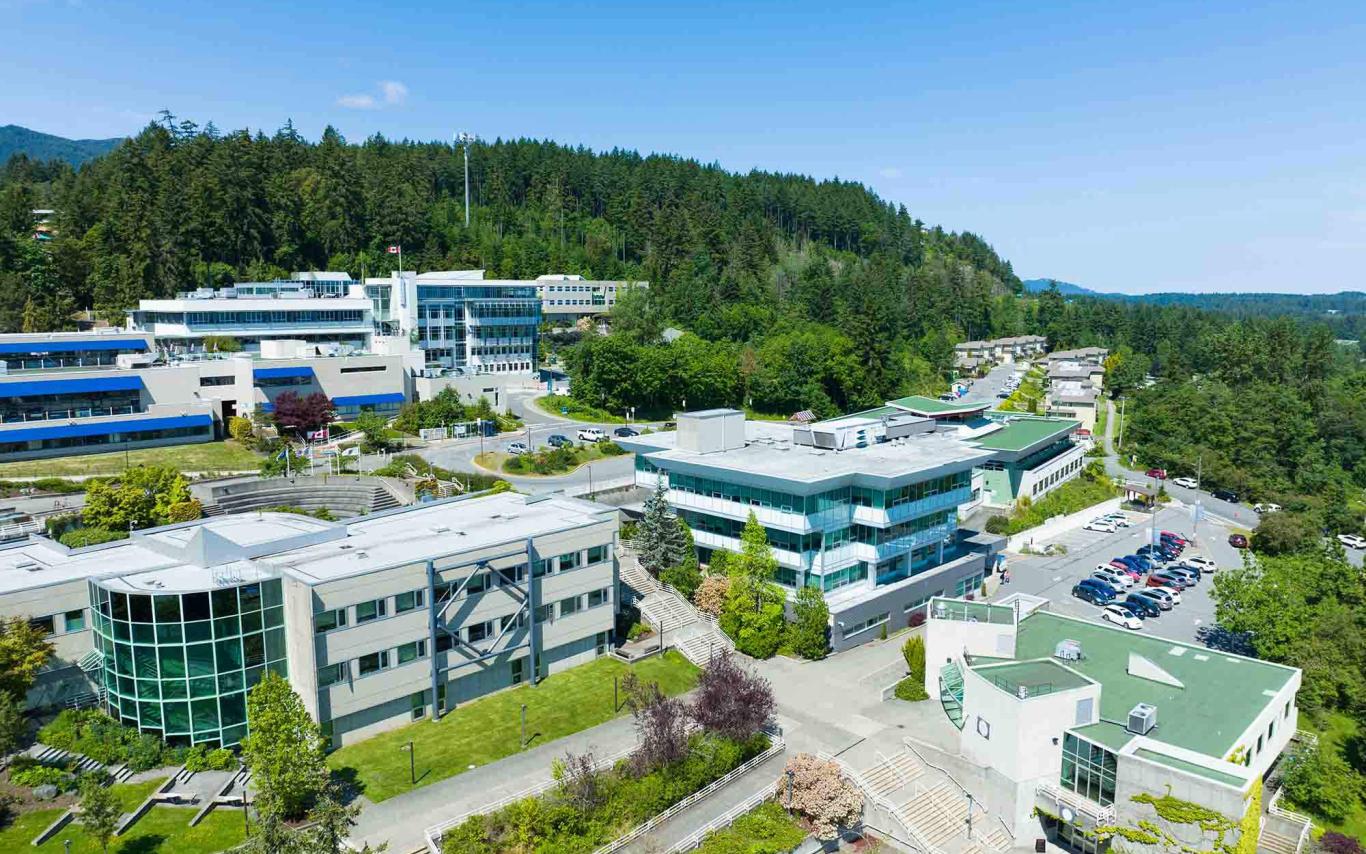 buildings nestled into a hillside under a blue sky.