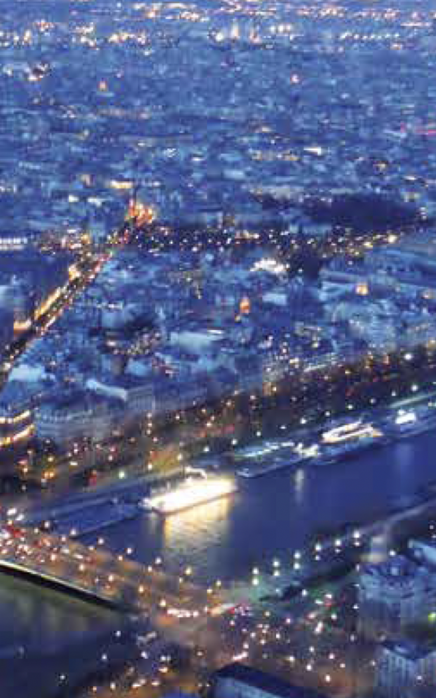 Arial view of a city with a river running through it at night.