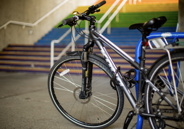 A bicycle in front of rainbow coloured stairs. 
