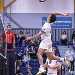 Volleyball player jumping to spike the ball. 